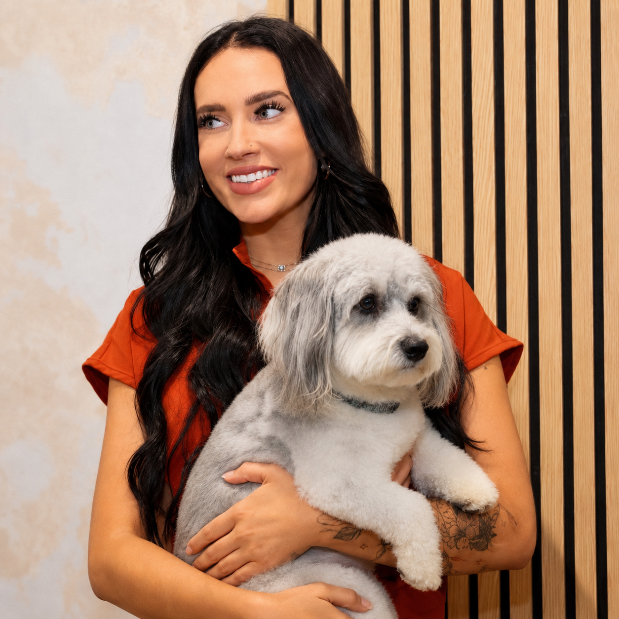 Haley Warren holding a freshly groomed dog at April’s Pet Grooming in Red Oak, Texas