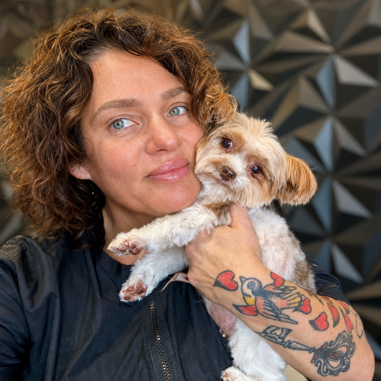 April Warren holding a small dog at April’s Pet Grooming in Red Oak, Texas