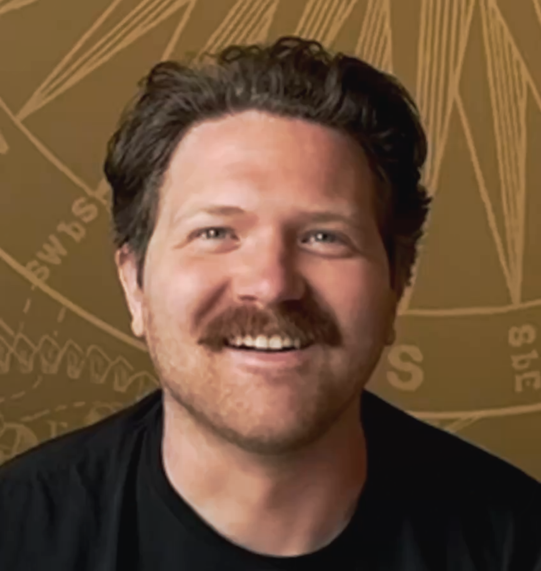 Close-up of a person's smiling face, showing their eyes, nose, and mouth, with a dark-colored shirt and a patterned background.