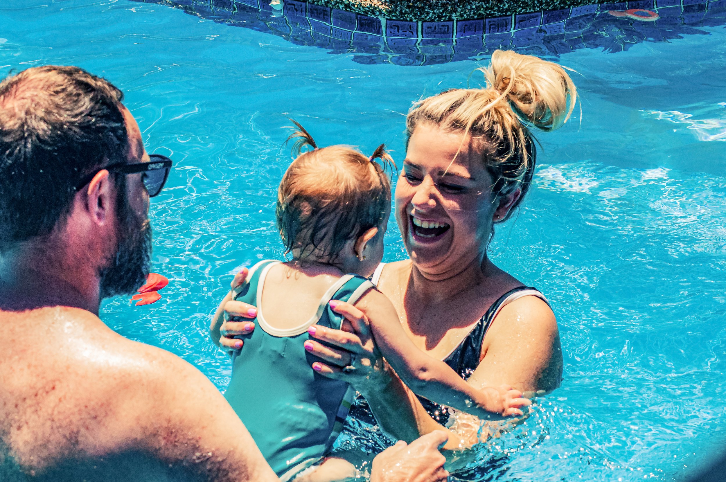 A mother and child having fun in the pool.
