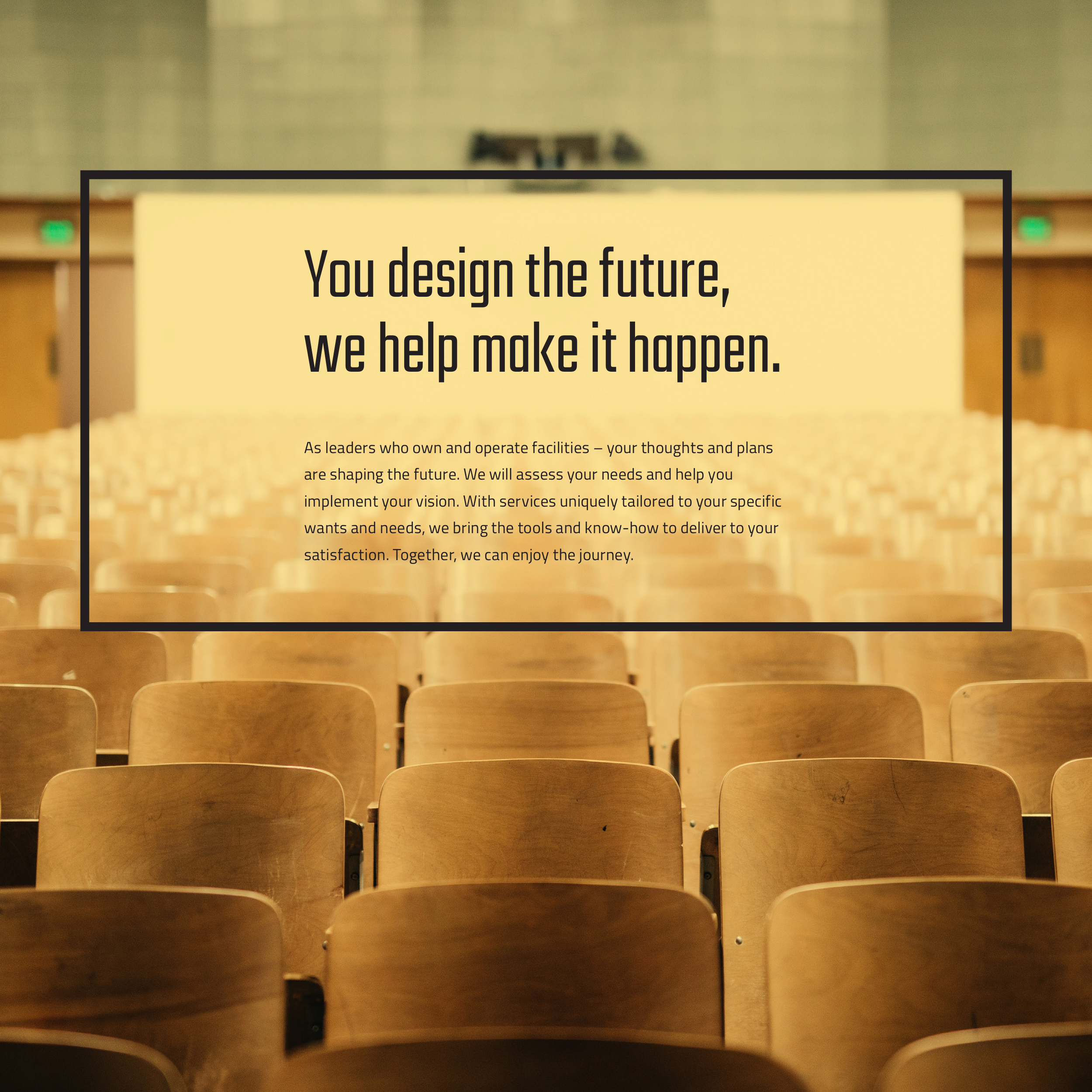 Empty auditorium with brown wooden chairs arranged in rows, viewed from the front facing the stage. There is a large screen displaying text about designing the future.