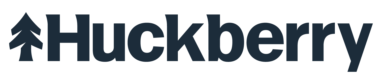 The logo for Huckberry, featuring a stylized pine tree icon to the left of the brand name in bold, dark letters.