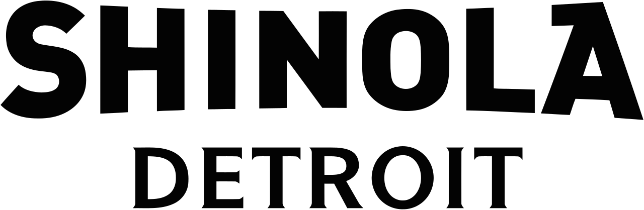 Black text on a transparent background says "SHINOLA DETROIT."