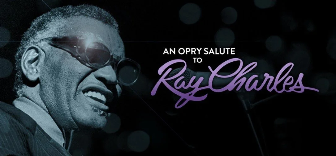 Black and white photo of Ray Charles wearing sunglasses and smiling, with purple cursive text that reads 'An Opry Salute to Ray Charles'.