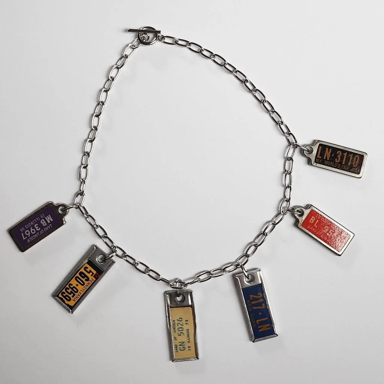 Steel chain and vintage license plate charms (2024)