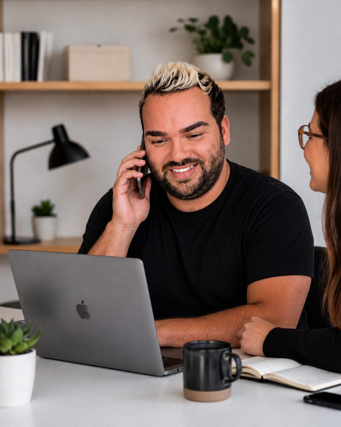 Viber ecommerce marketing consultant smiling while talking on phone and working on laptop