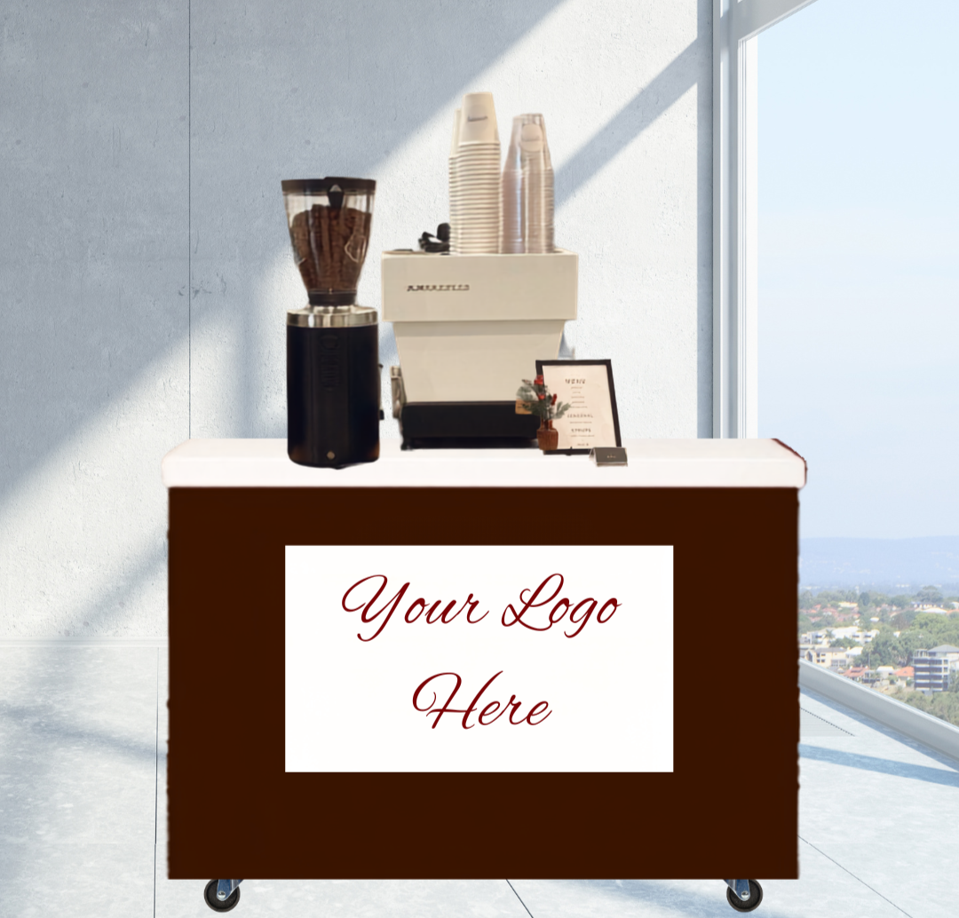 Coffee station with a coffee grinder, coffee machine, disposable cups, and a small decorative plant, set against a window with a city view. A banner on the front of the cart reads 'Your Logo Here.'