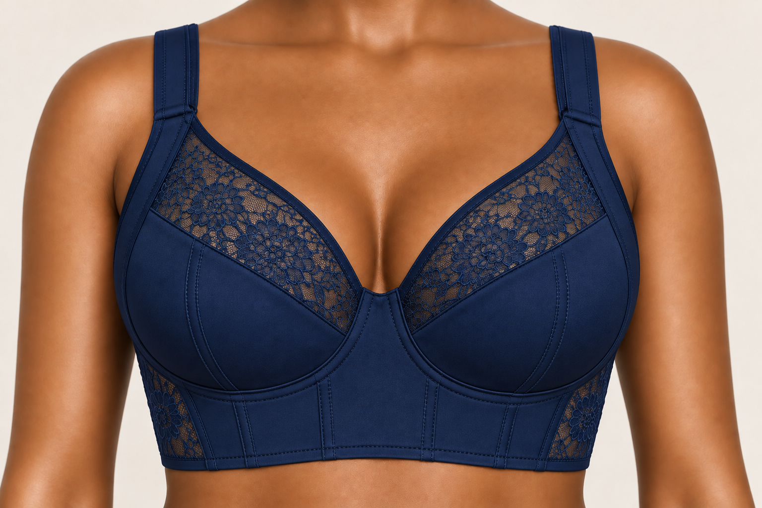 Close-up of a woman wearing a blue lace and padded bra, showing her upper torso from neck to midriff.