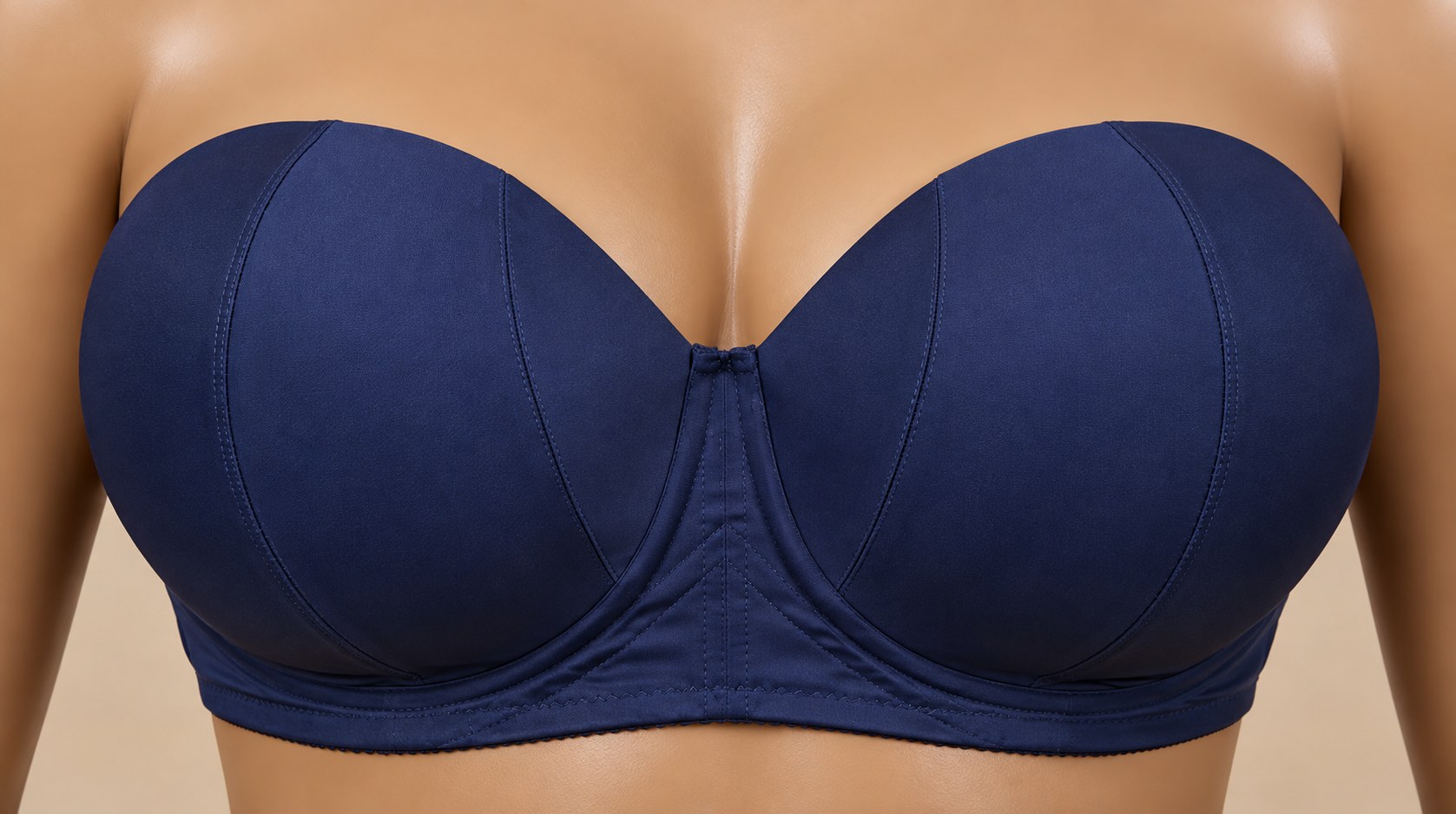 Close-up of a woman's chest wearing a navy blue strapless bra with underwire design.