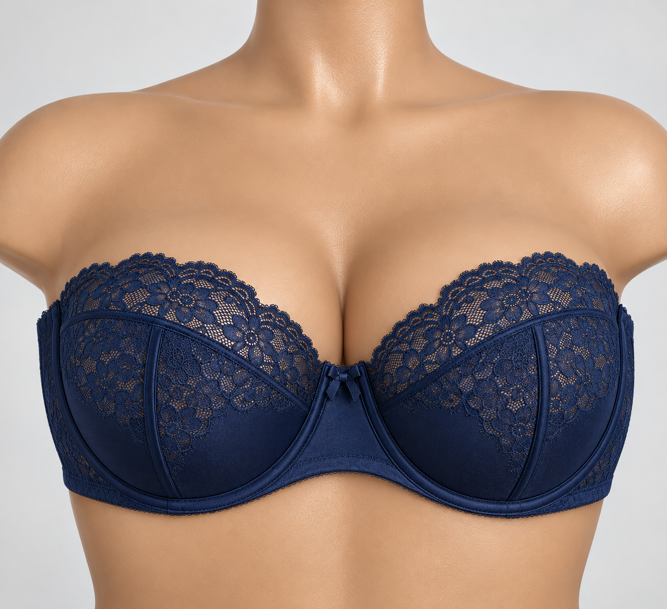 A woman wearing a blue lace bra with floral embroidery.