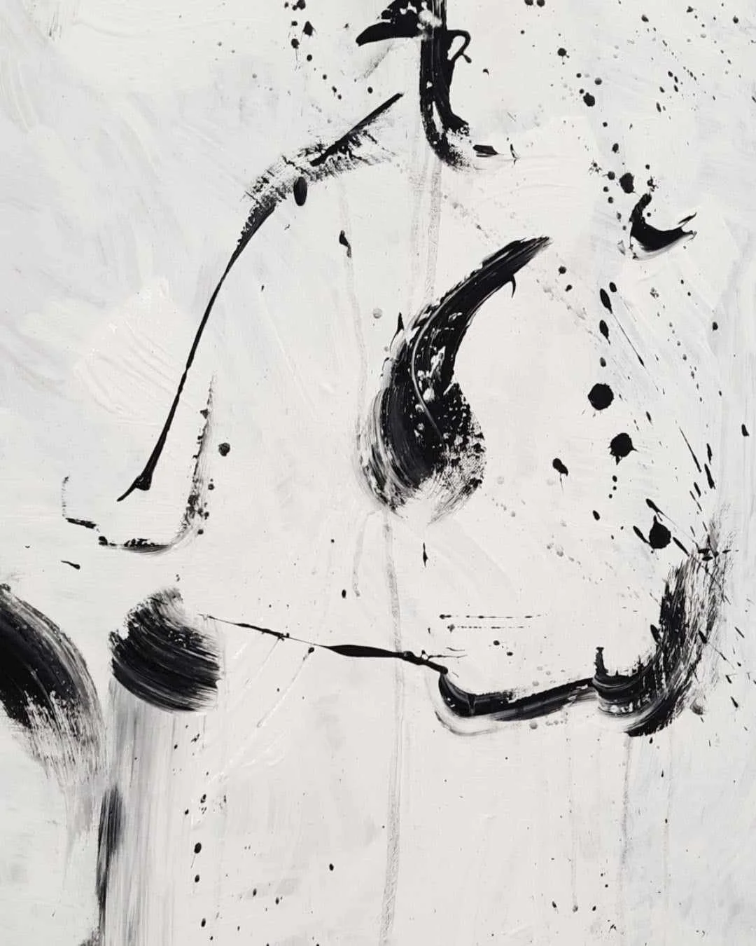 Abstract black ink splatters and strokes on a white background, resembling a modern art painting.
