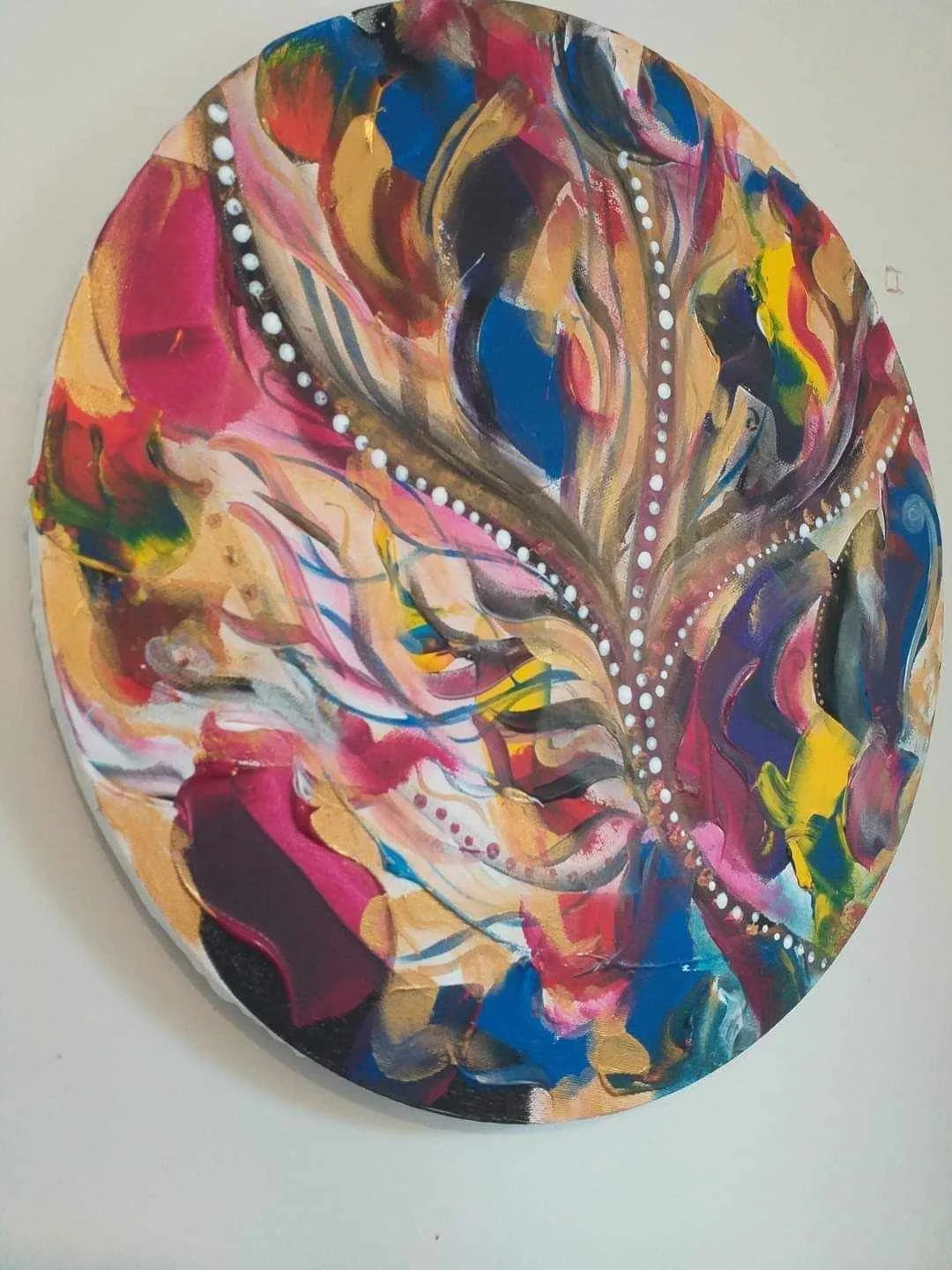 Abstract colorful artwork on a circular canvas with swirling patterns and dotted white lines.