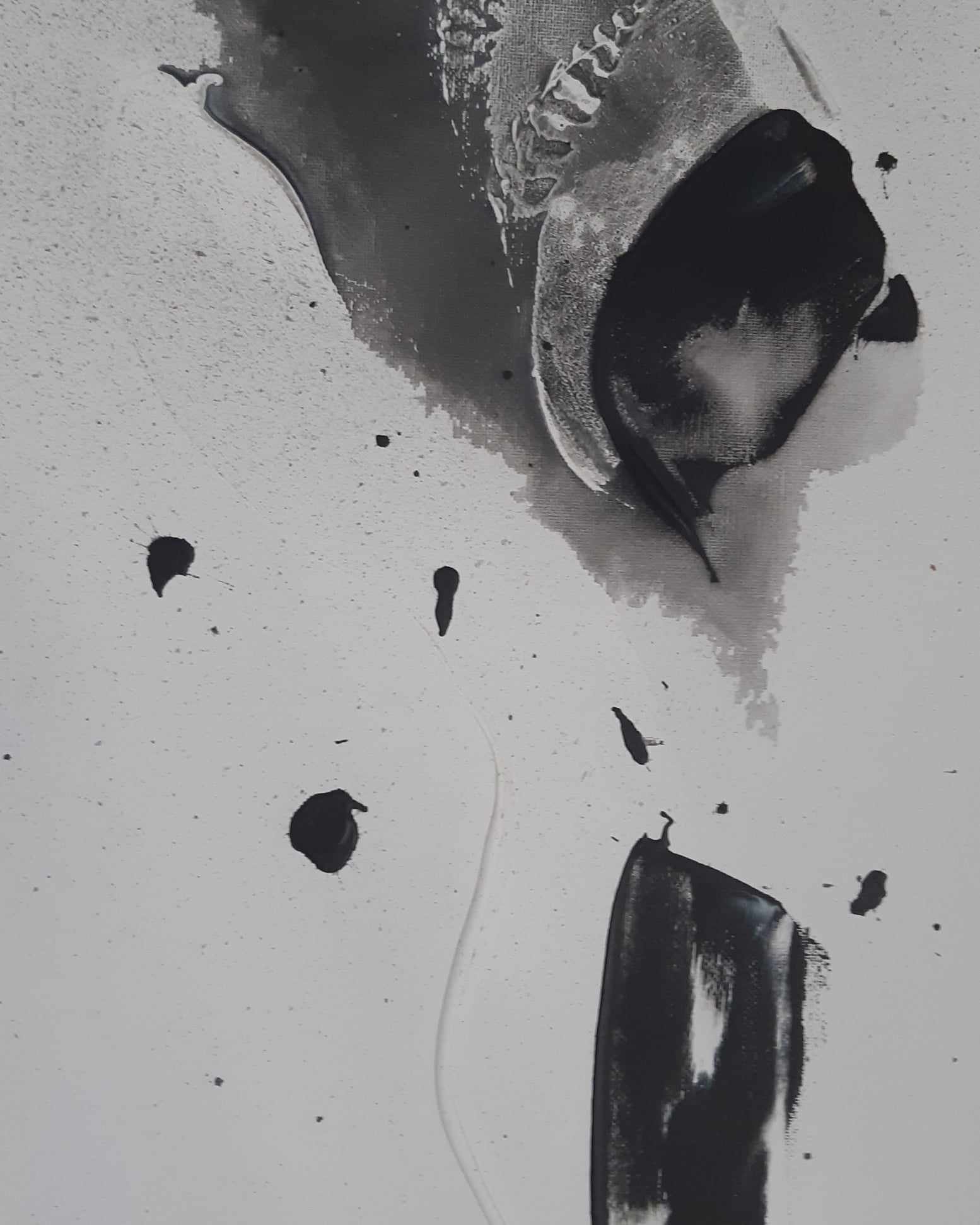 Abstract black and white watercolor painting with splashes and drips.