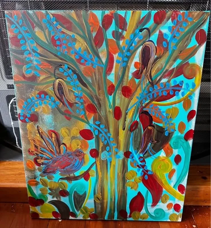 Colorful painting of a tree with blue, red, orange, and green leaves, a bird at the bottom left, and a blue background.
