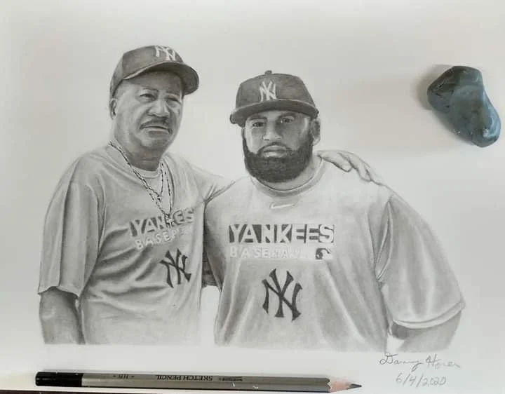 Pencil drawing of two men wearing New York Yankees baseball shirts and caps, with one man's arm on the other's shoulder, with a rock and a marker in the background.