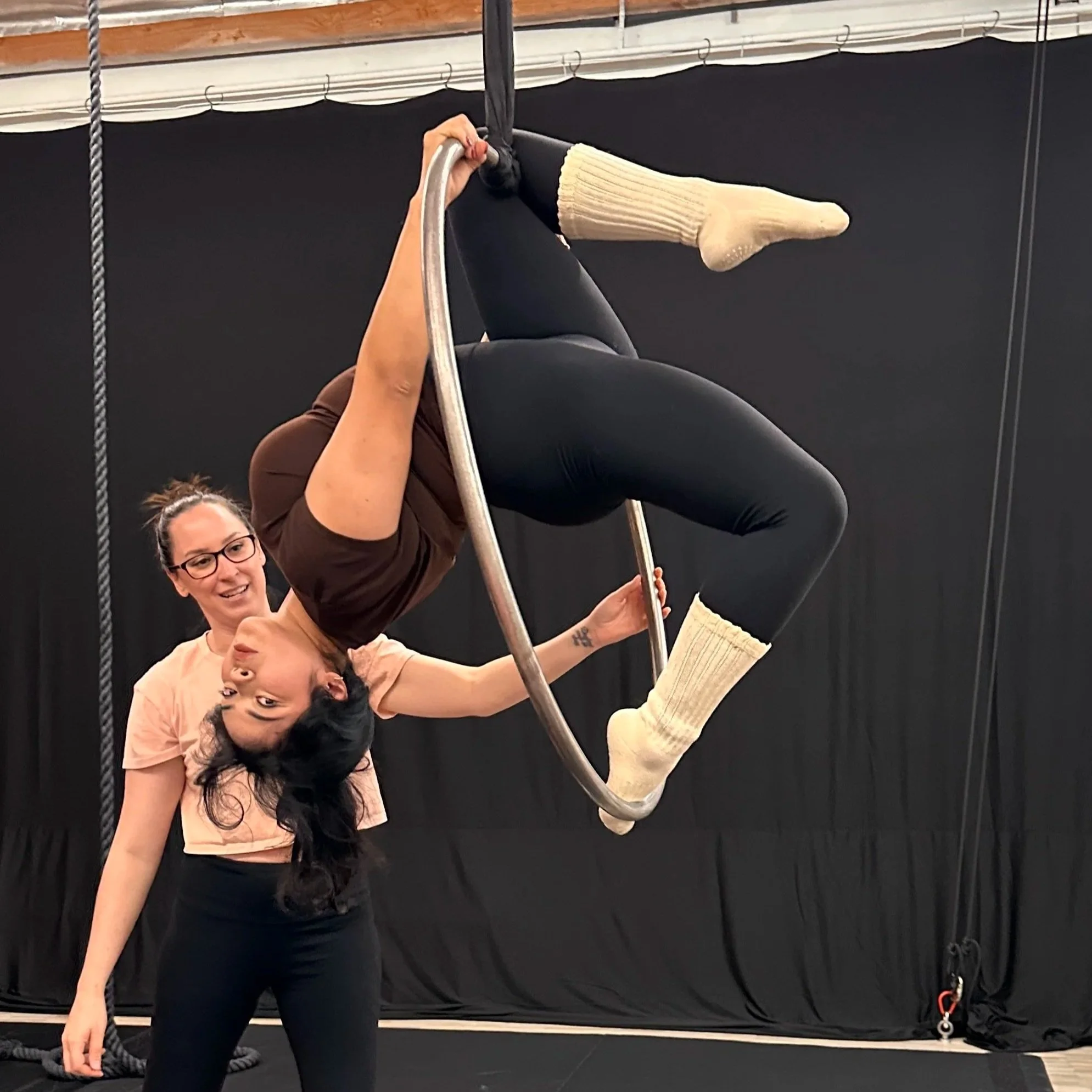 Beginner aerial student on aerial hoop (lyra).