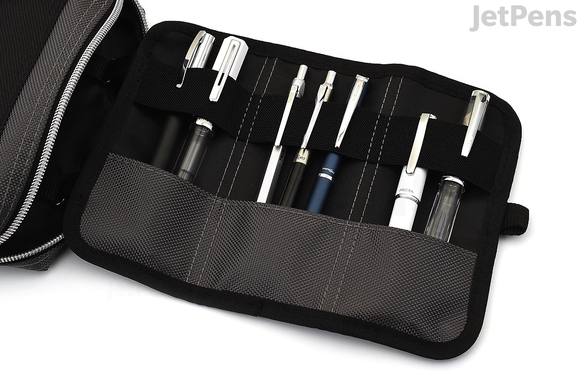 A black case with multiple pens and styluses, including black, white, blue, and transparent tips, inside a bag.