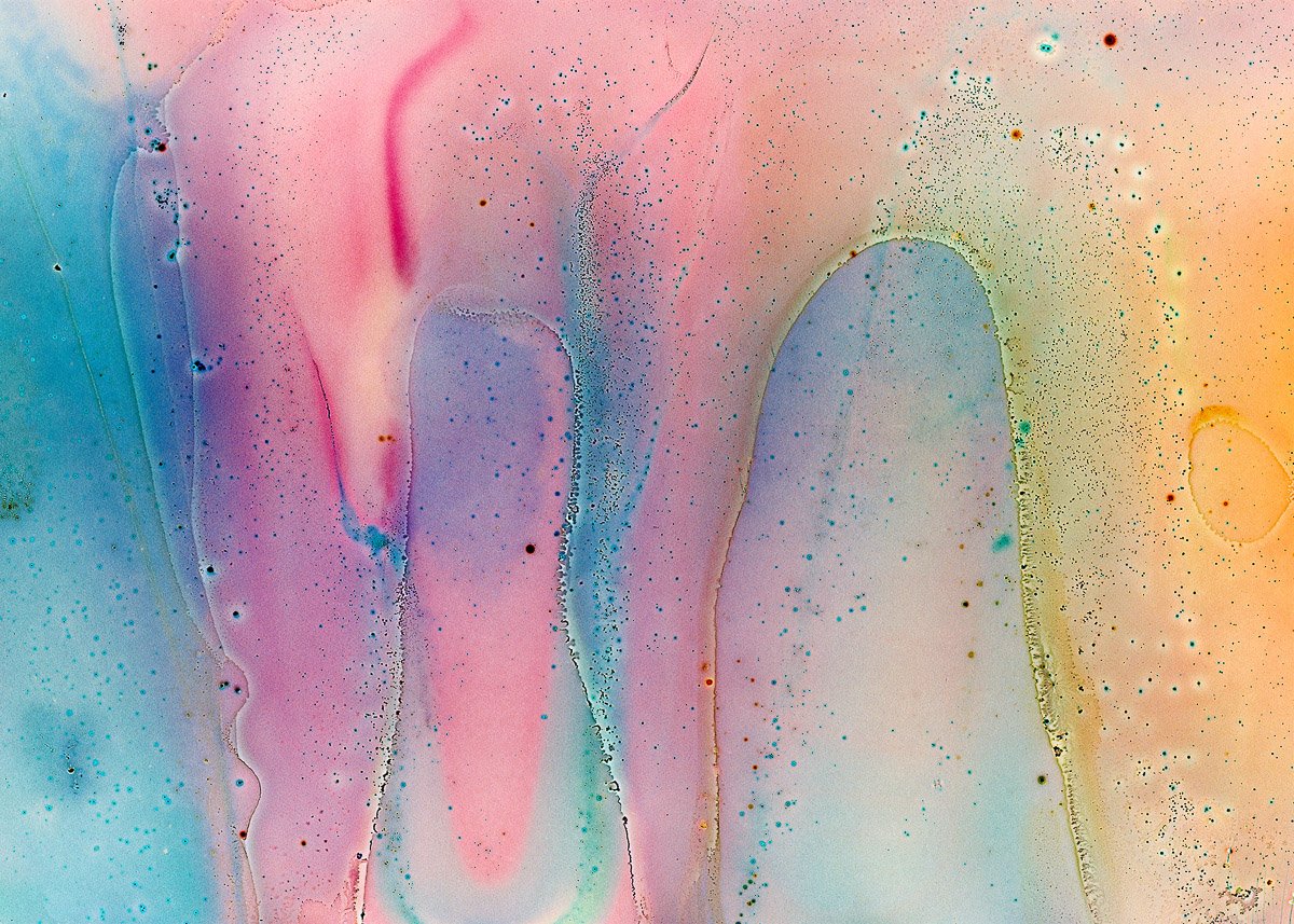 Abstract watercolor painting with flowing pastel colors including pink, blue, green, and yellow, and speckled textures.
