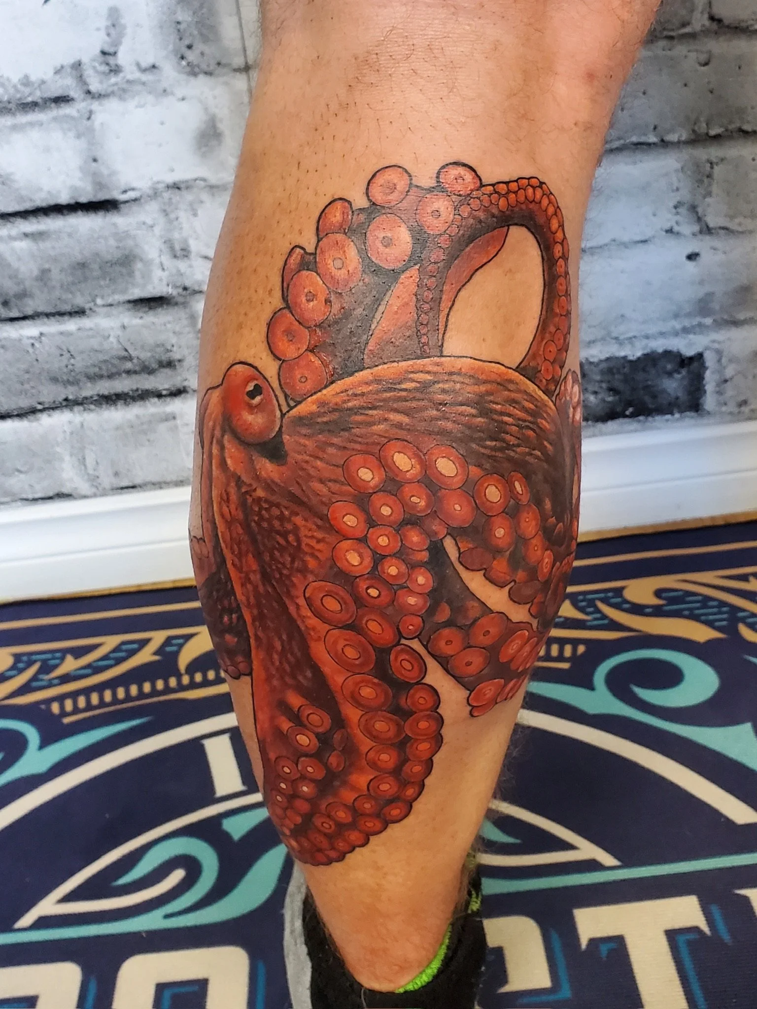 Tattoo of an octopus tentacle on a person's leg.