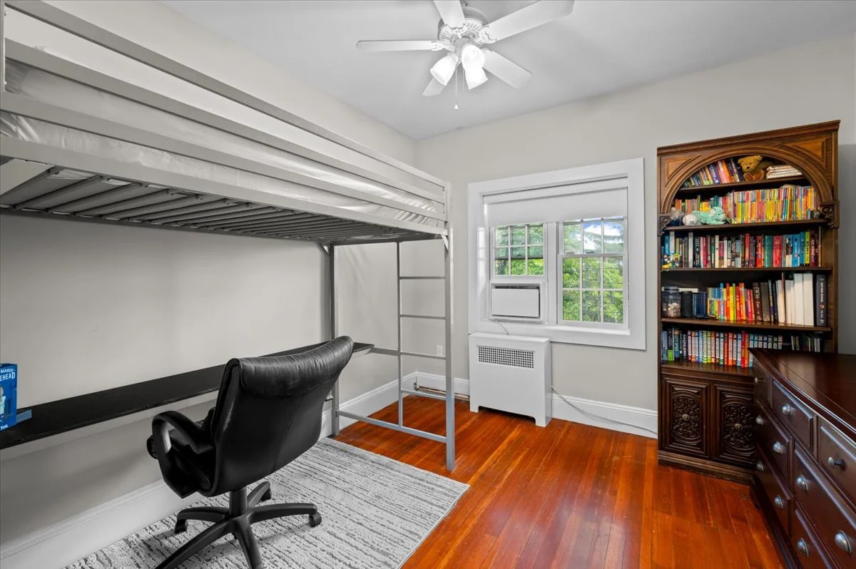 Second bedroom on second level, tree-lined street view, Eastern exposure, closet