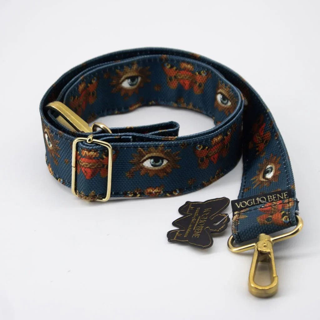 Collier pour chien en tissu bleu avec motifs d'yeux et de fleurs, avec boucle en métal doré et boucle de fixation.