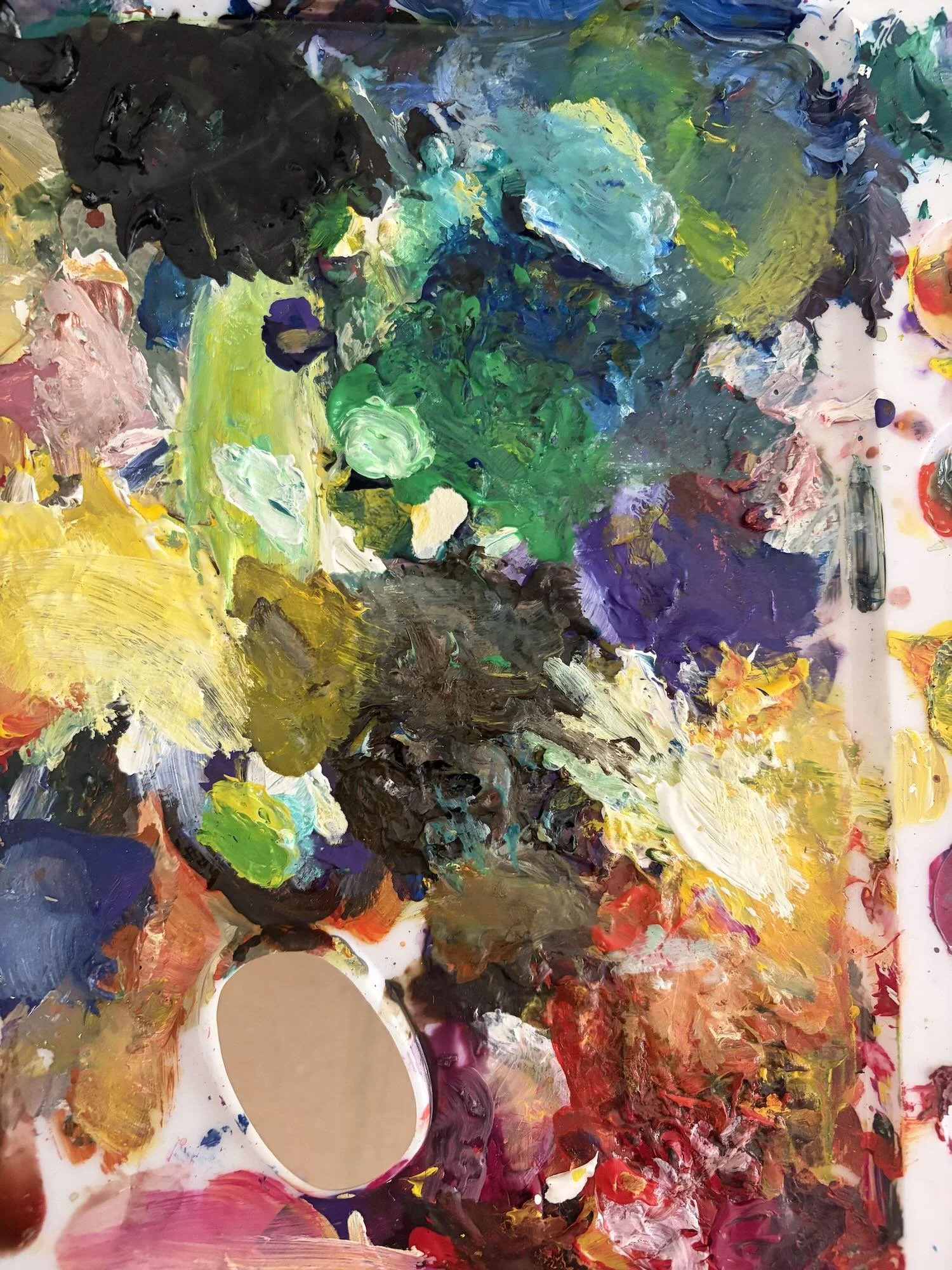 Abstract colorful painting with thick brushstrokes and a palette with various shades of green, blue, black, purple, red, yellow, and white.