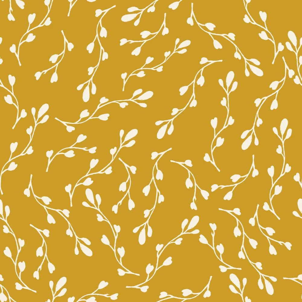 White floral pattern on a mustard yellow background.