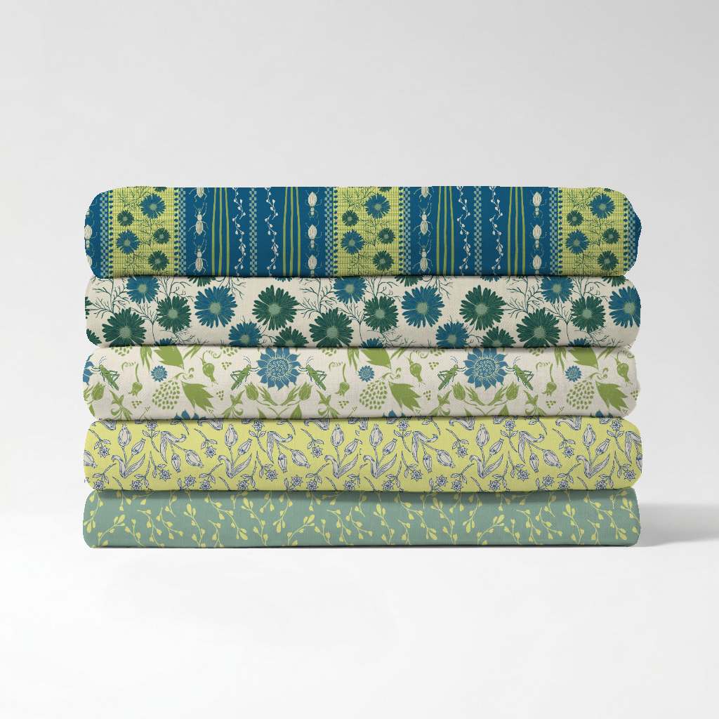 Stack of five folded fabric pieces with floral and botanical patterns in green, blue, and white, arranged on a white background.