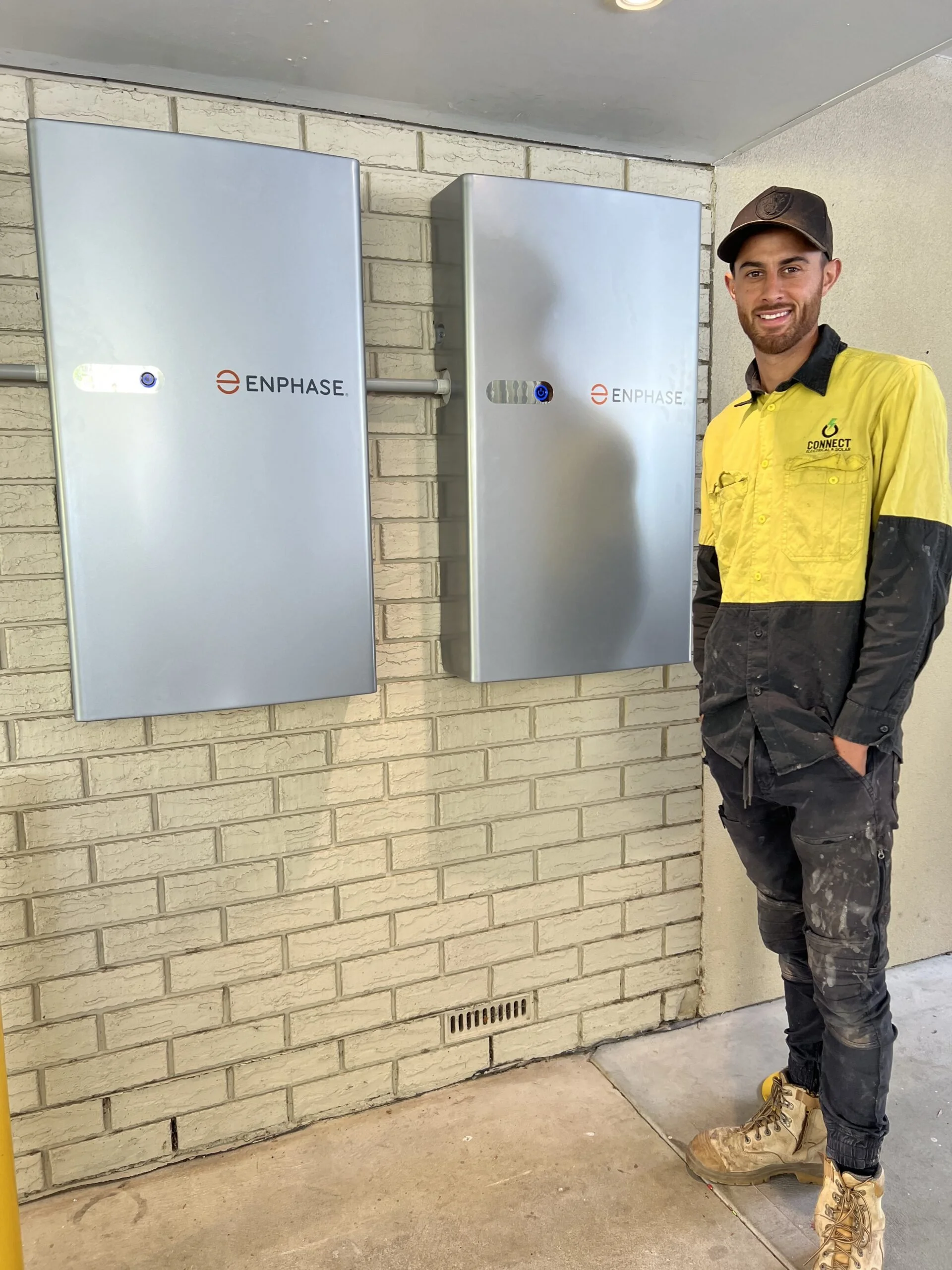 Dillon Williams from Connect Electrical & Solar standing beside a residential solar installation