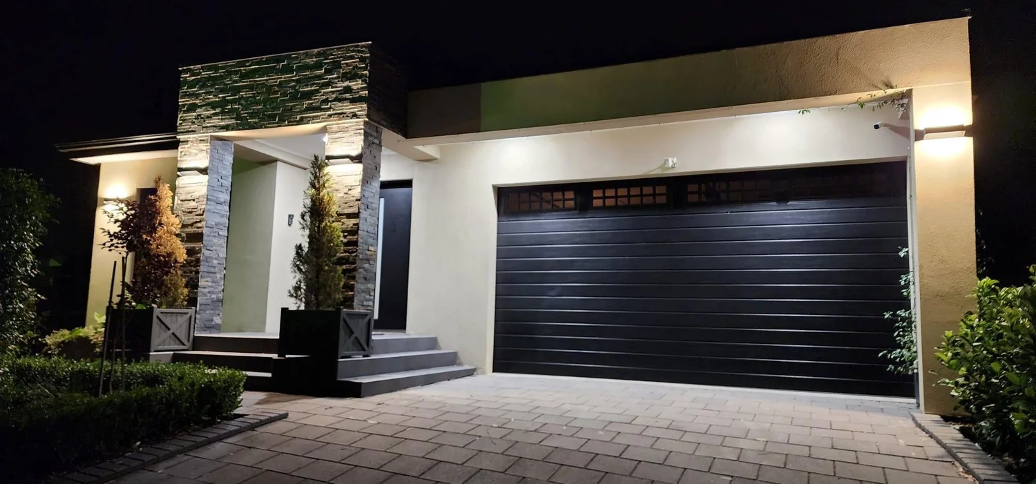 Exterior lighting illuminating a residential home at night, installed by Connect Electrical & Solar