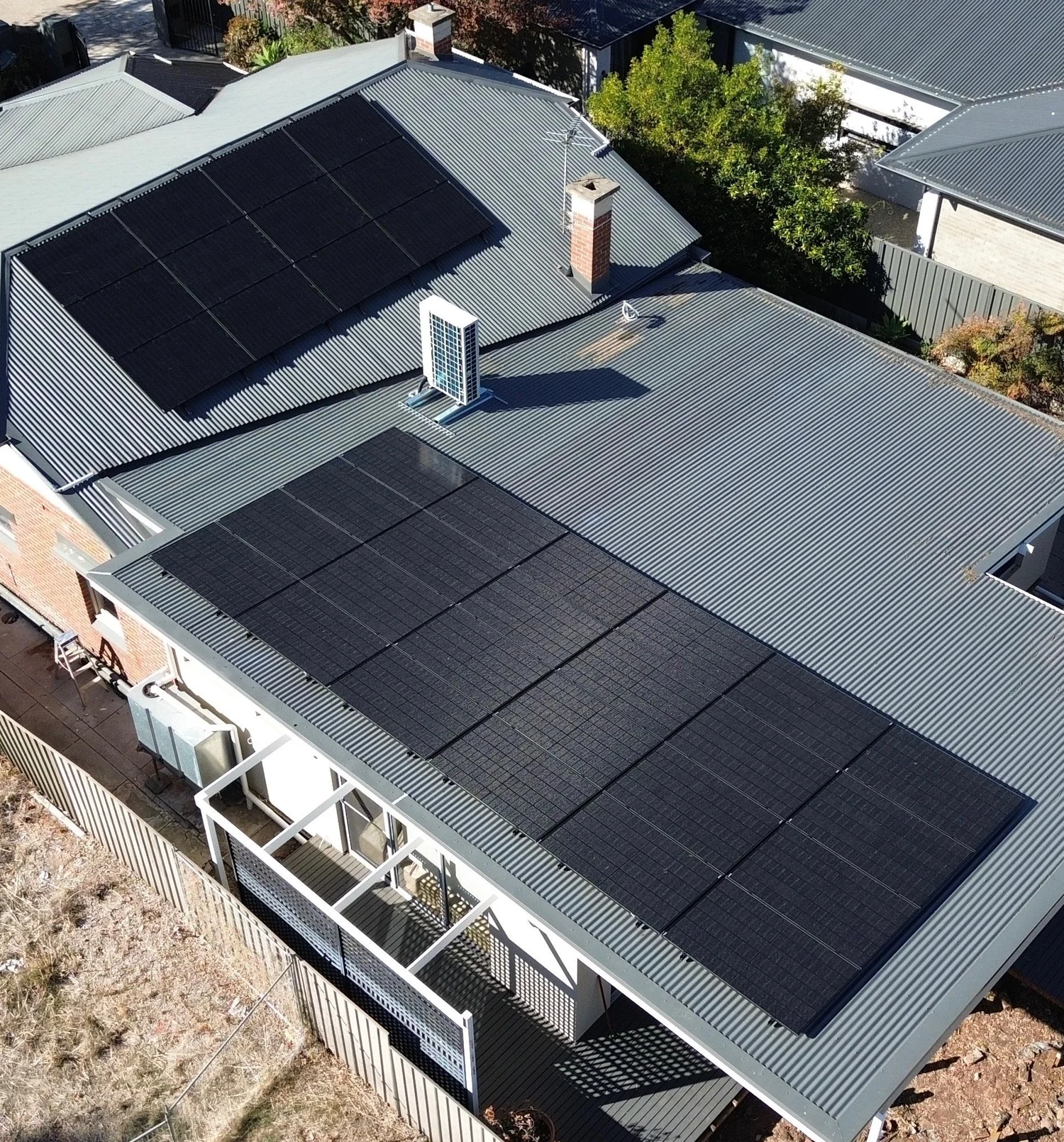 Aerial view of rooftop solar panels installed on a residential home by Connect Electrical & Solar