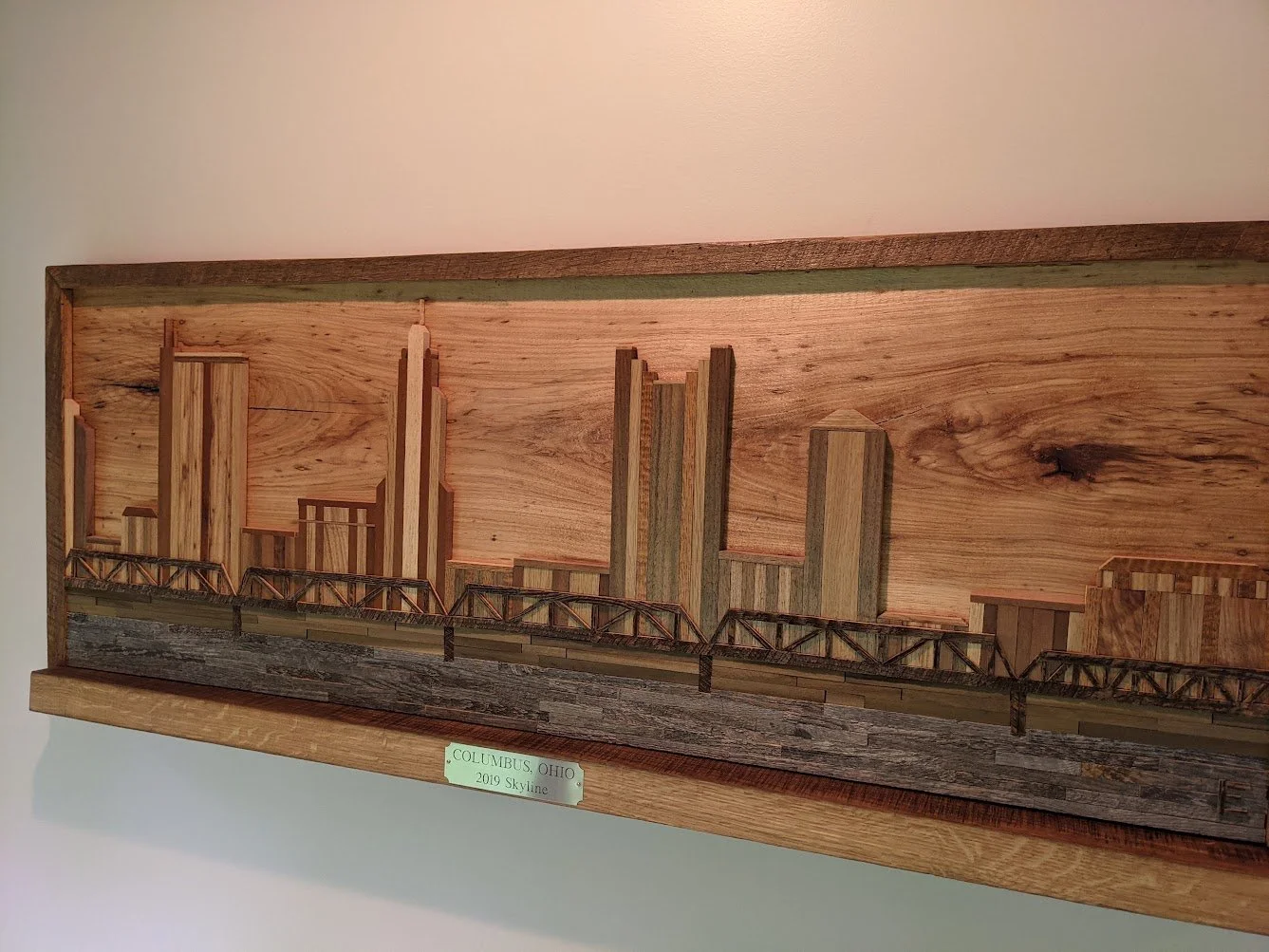 Wooden cityscape model with buildings and bridge, labeled 'Columbus, Ohio, 2019 Skyline'