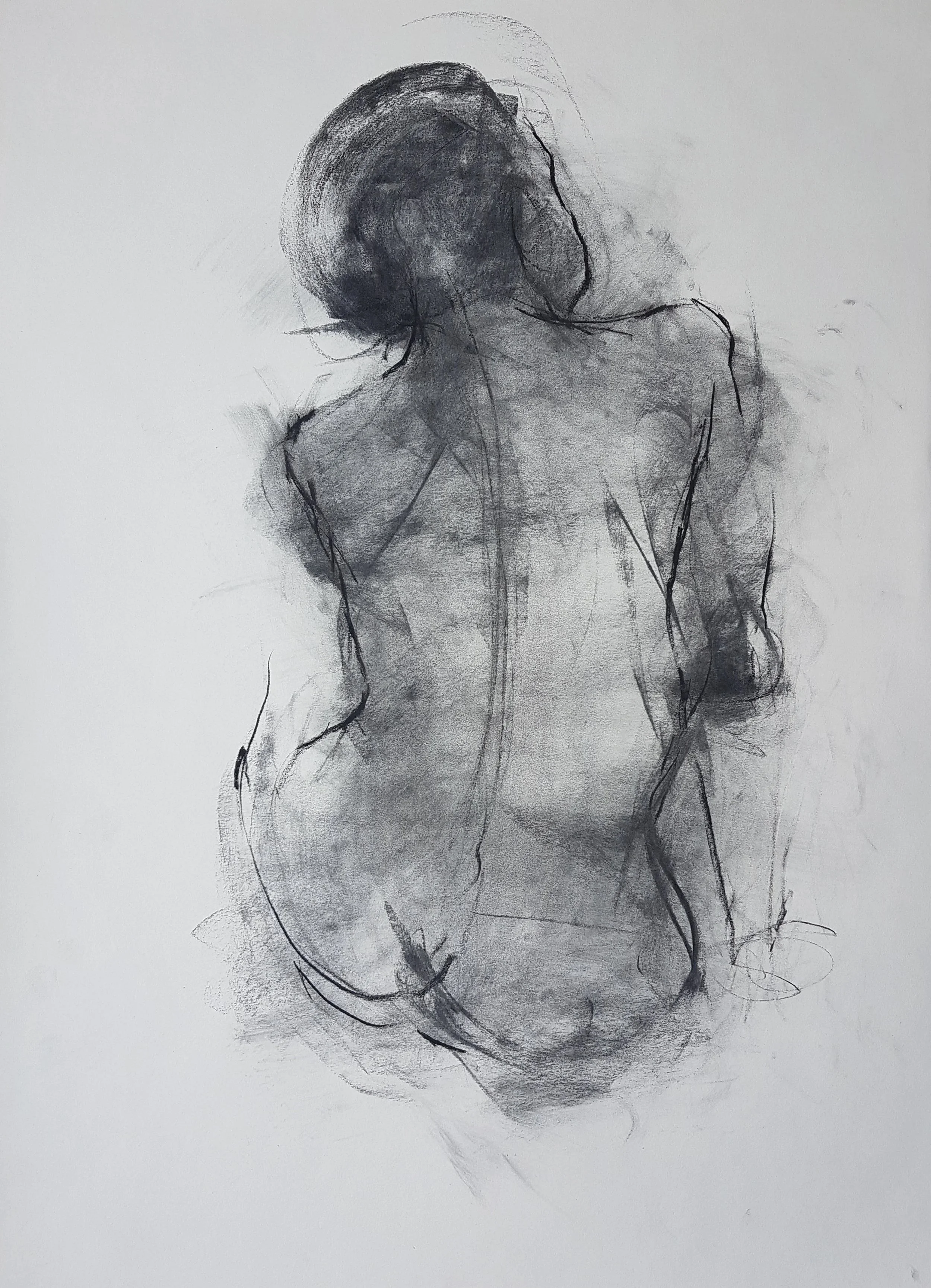A gentle portrait in charcoal of the back profile of a female nude model who is lightly cradling her right arm, staring off wistfully in the distance, thinking of her lost love.