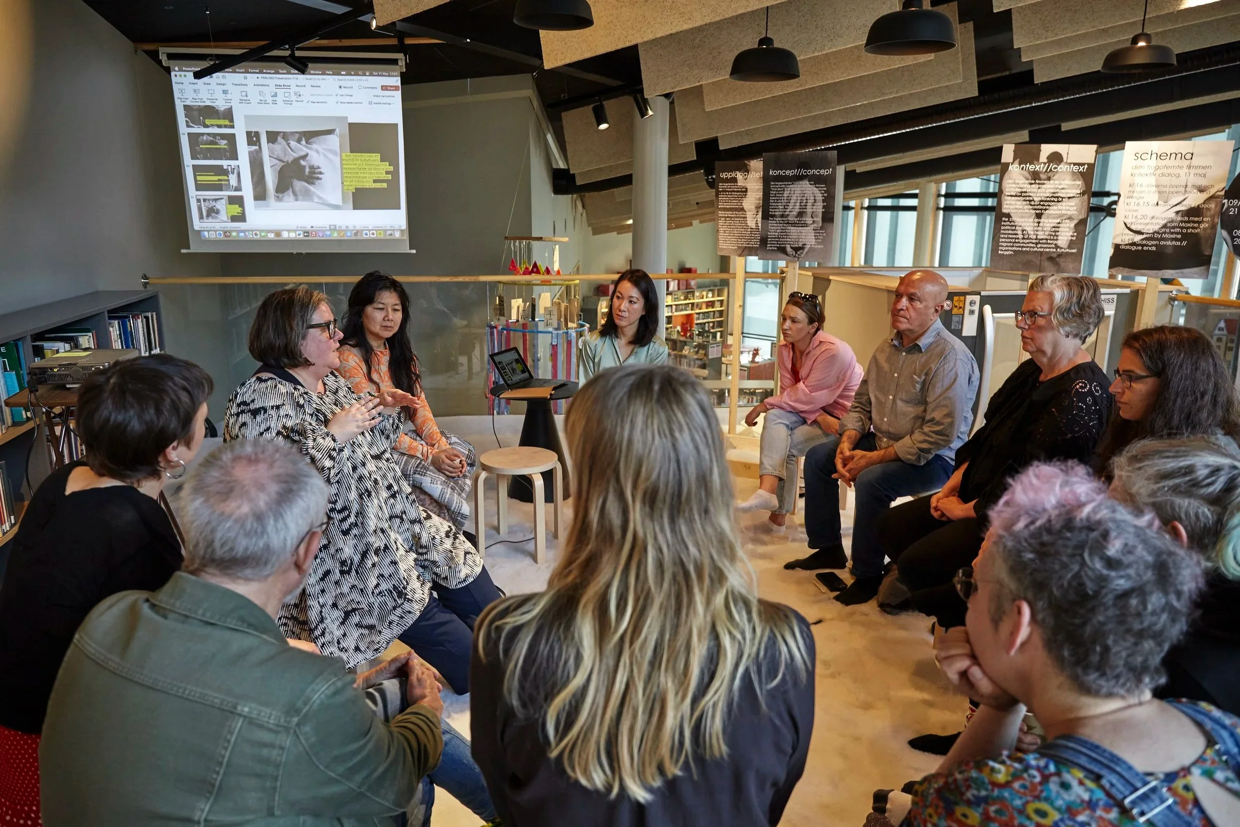 A group of people gathered in a circle, listening intently to one another as they participate in a collective dialogue.