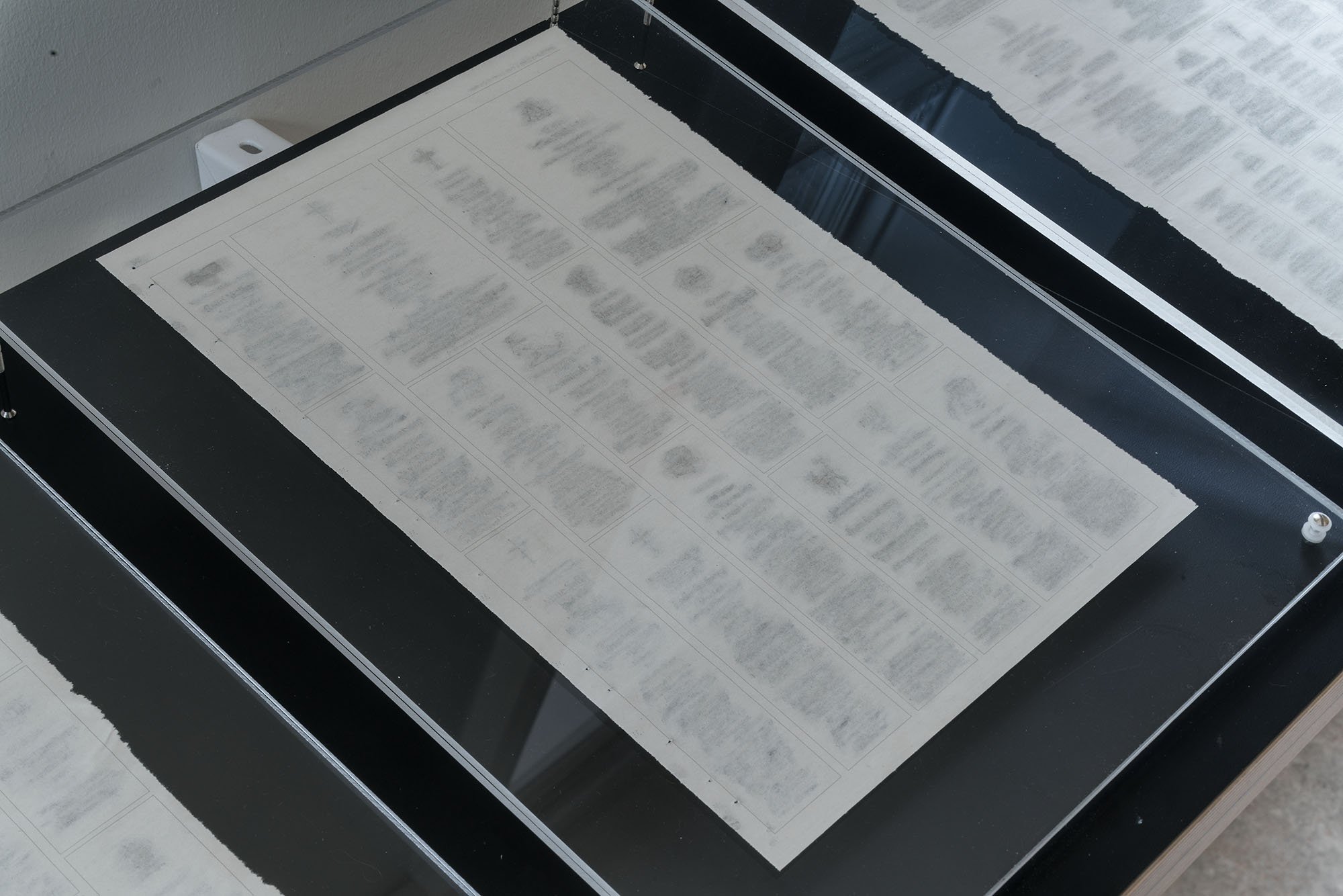 Close-up view of one of the pages of the Swedish newspaper with all the obituaries physically erased.