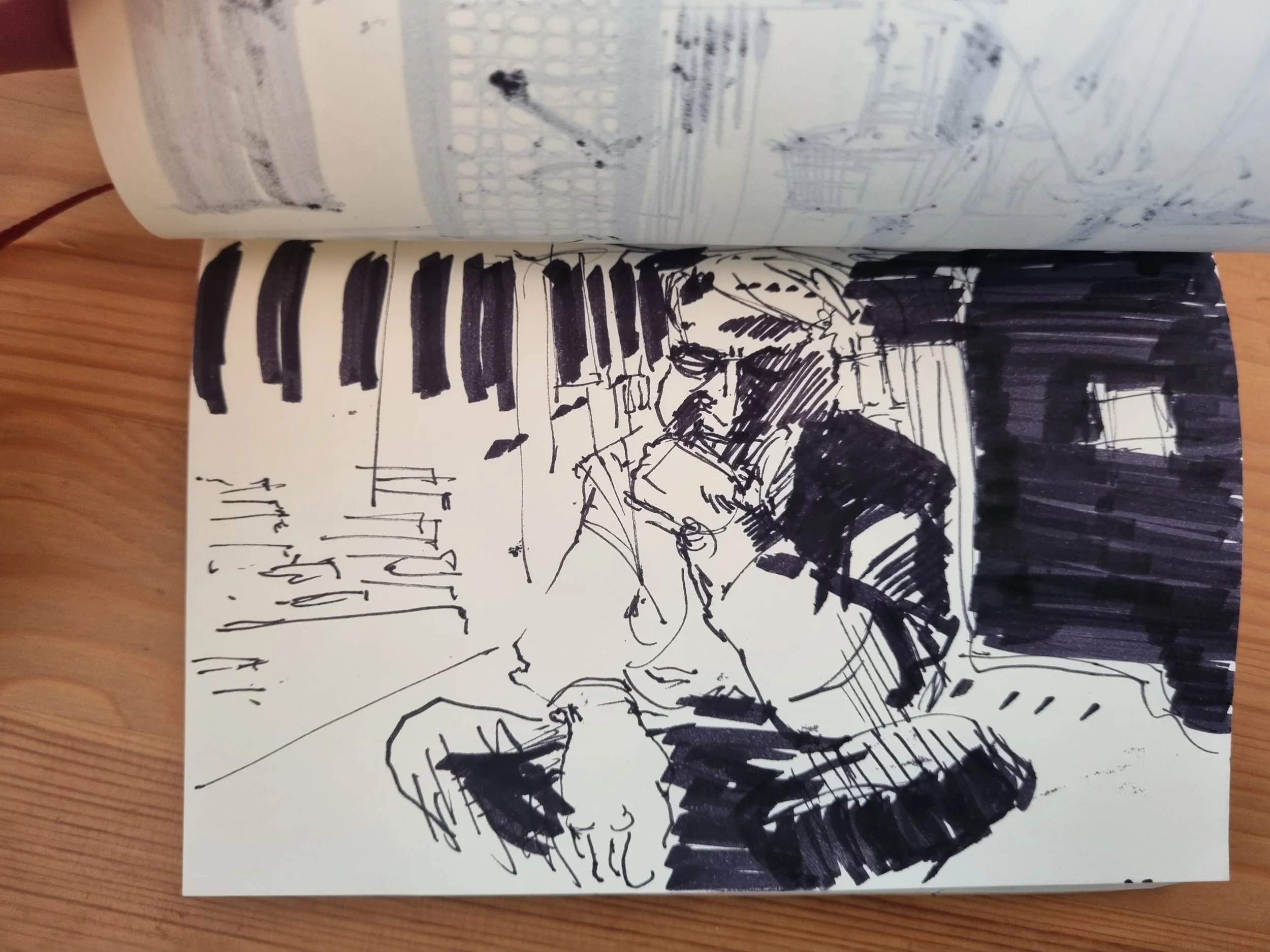 Sparse marker pen sketch with deep contrasting shadows of a man sitting cross-legged, gaze cast downwards, deep in thought.