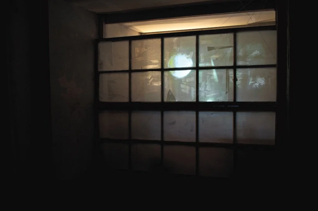 Installation view of video projection on rice paper screen as part of a site-specific installation.