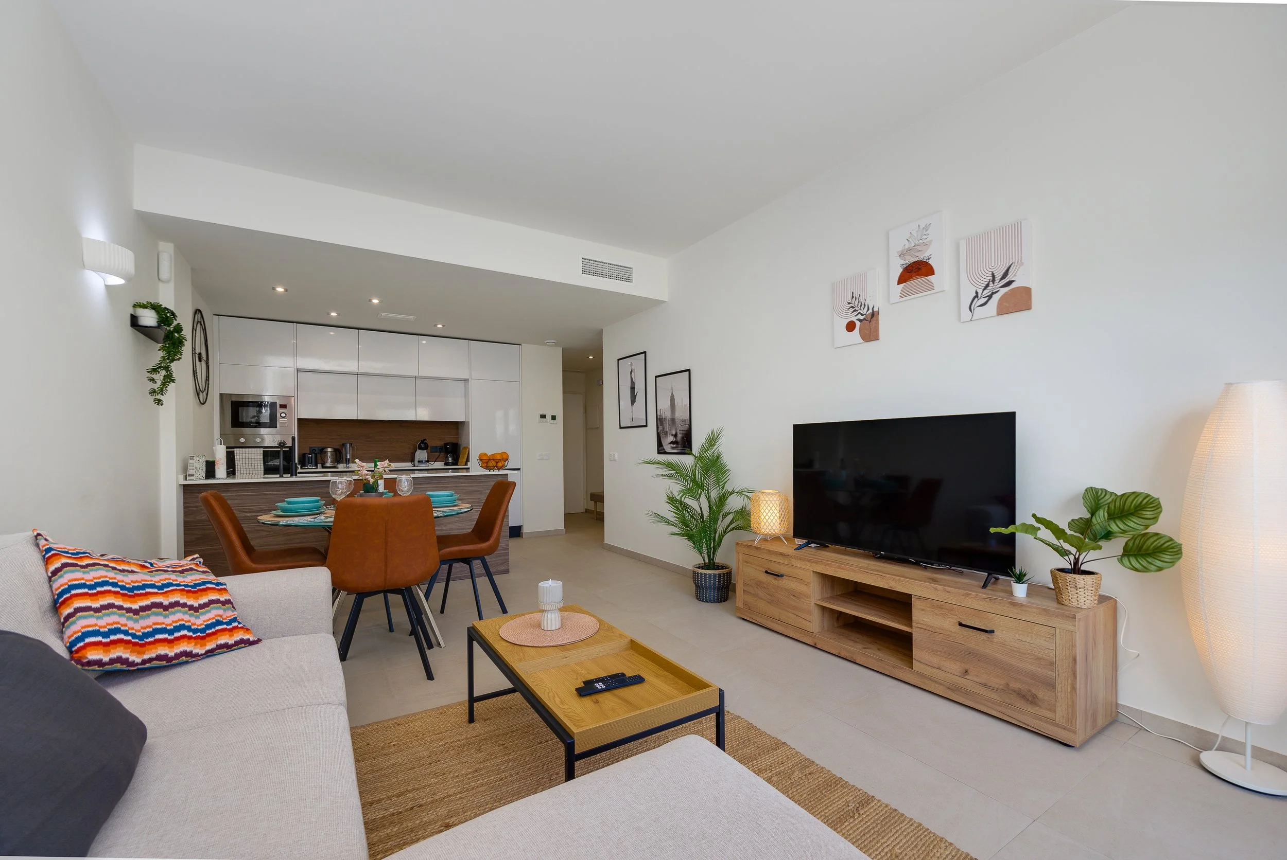 Bright, open-plan living space with a fully equipped kitchen and comfortable lounge area.