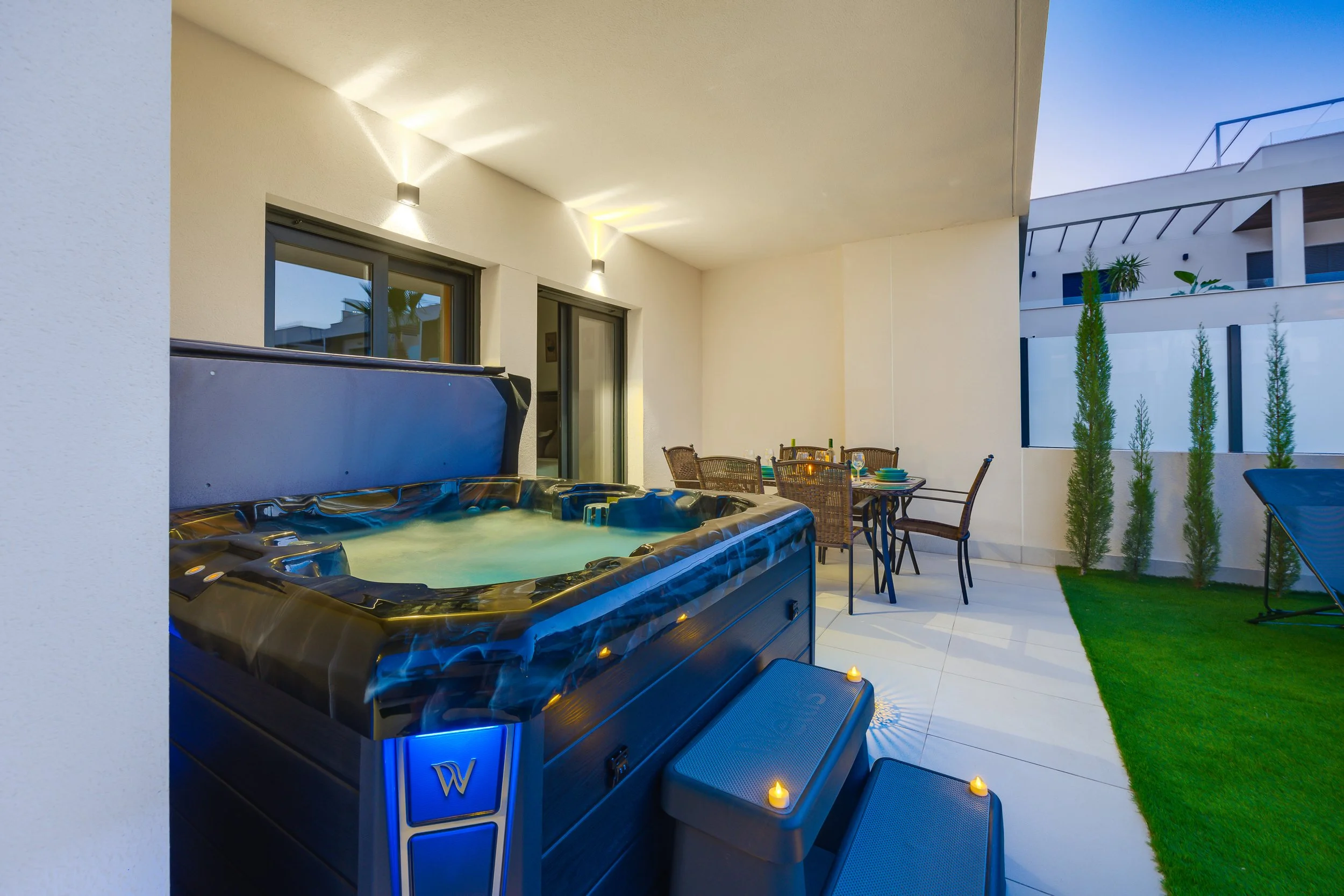 Unwind in your private hot tub after a day at the beach.