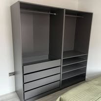 Empty black wardrobe with hanging space and drawers