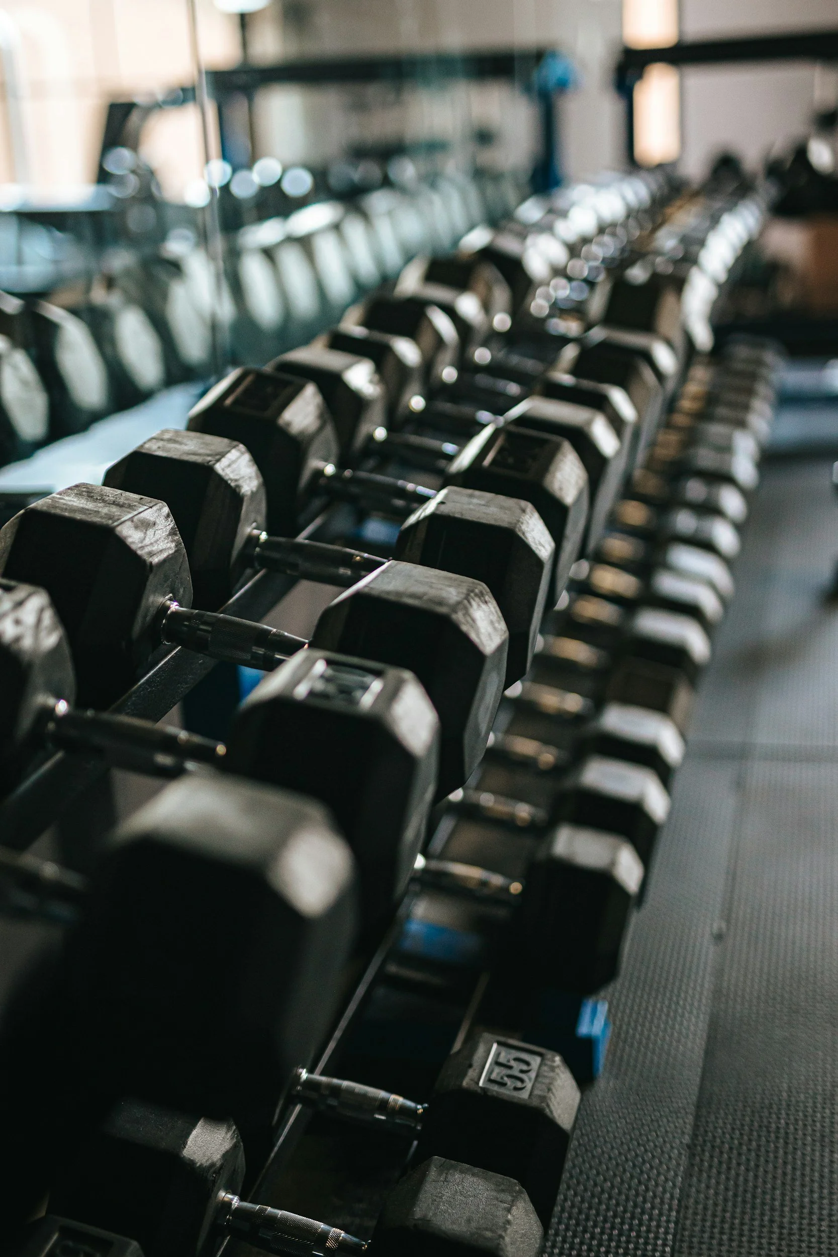 Gym weights representing physical discipline, strength, and consistent habits as part of the Mind. Body. Spirit. framework.