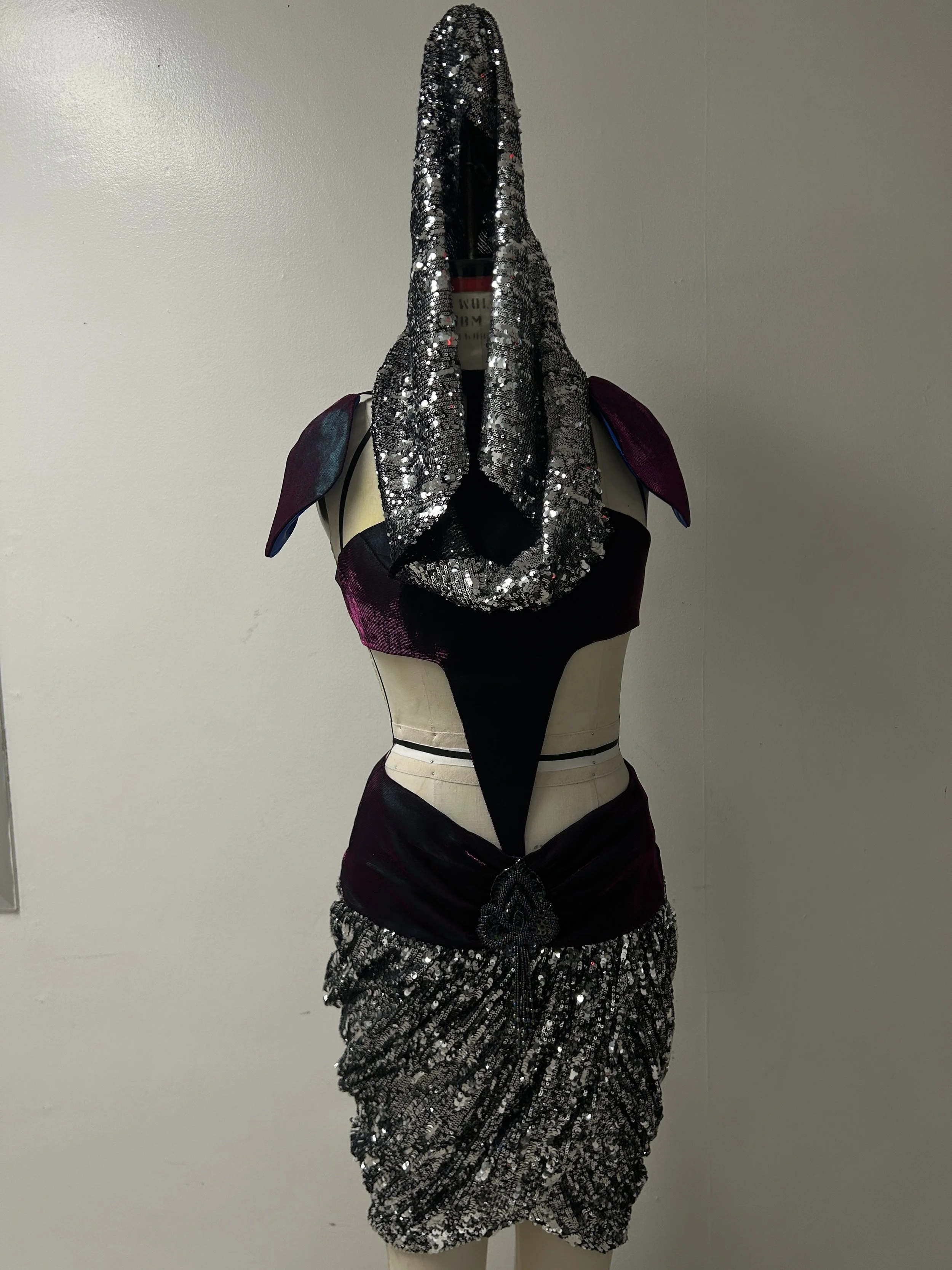 liquid organza and shimmer knit bodice and skirt yoke, knit sequin mini peg skirt and cowl hood.