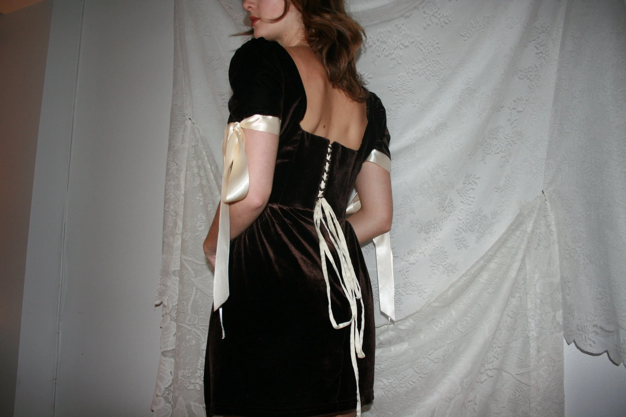 brown velvet puff sleeve dress made with upcycled skirt. Lace-up back with boned princess seam bodice