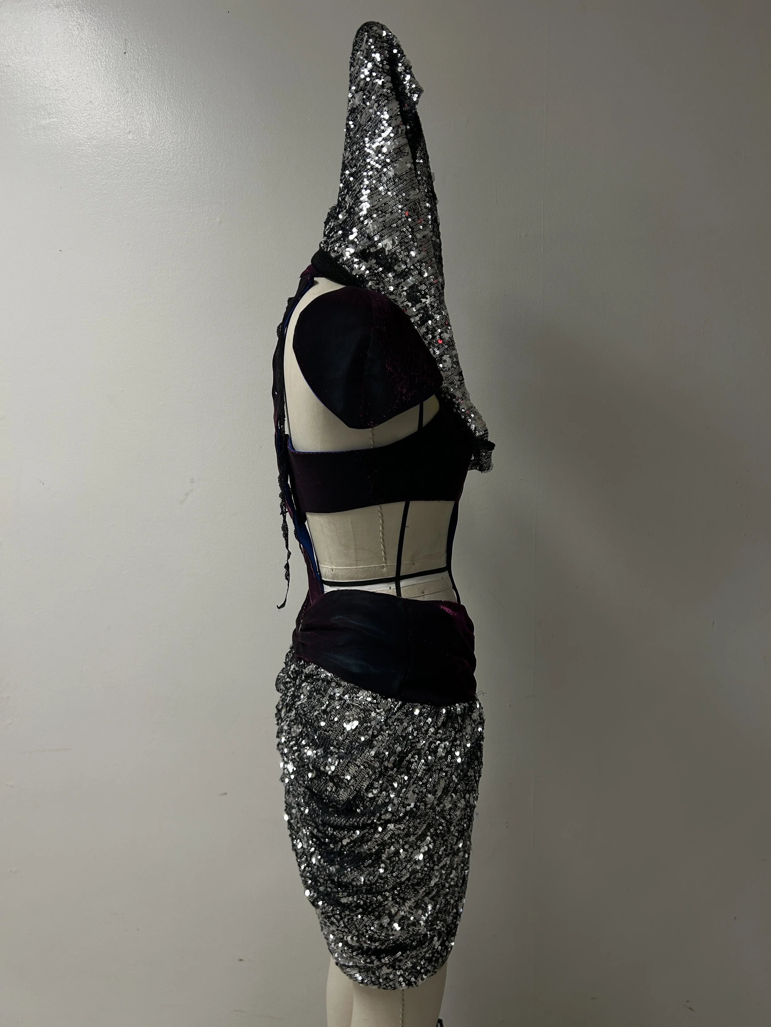 liquid organza and shimmer knit bodice and skirt yoke, knit sequin mini peg skirt and cowl hood.