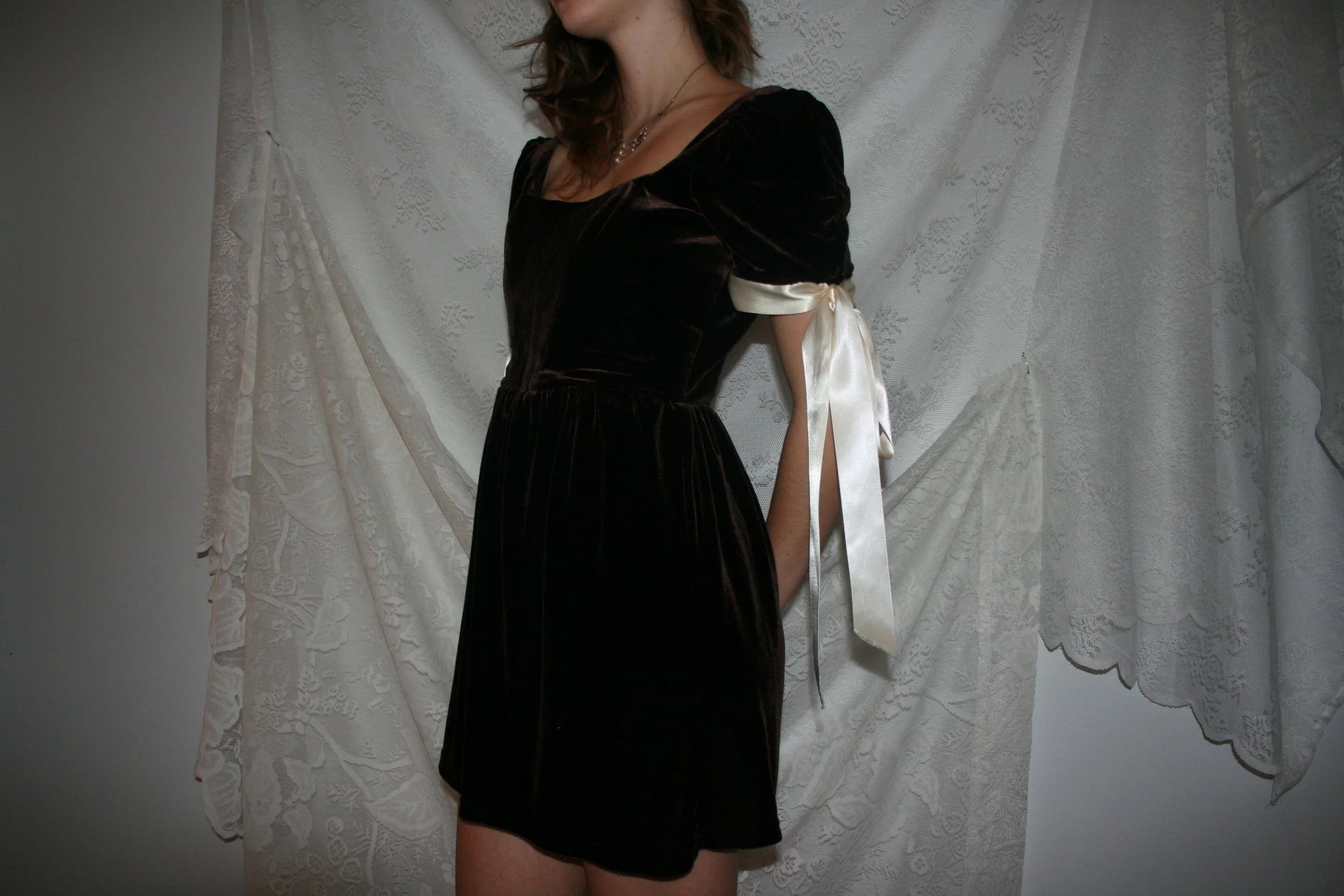 brown velvet puff sleeve dress made with upcycled skirt. Lace-up back with boned princess seam bodice