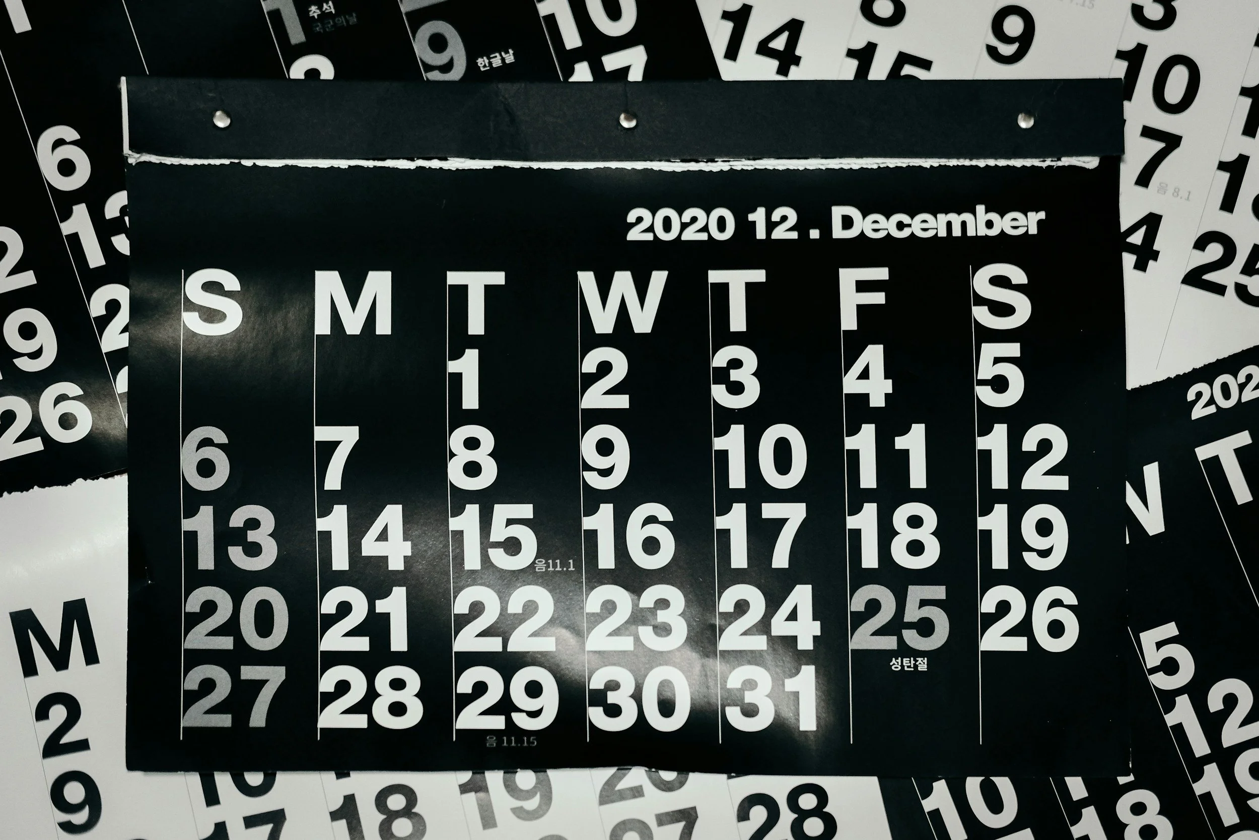 A collection of black and white calendar pages displaying the month of December 2020, with the days of the week and dates visible.