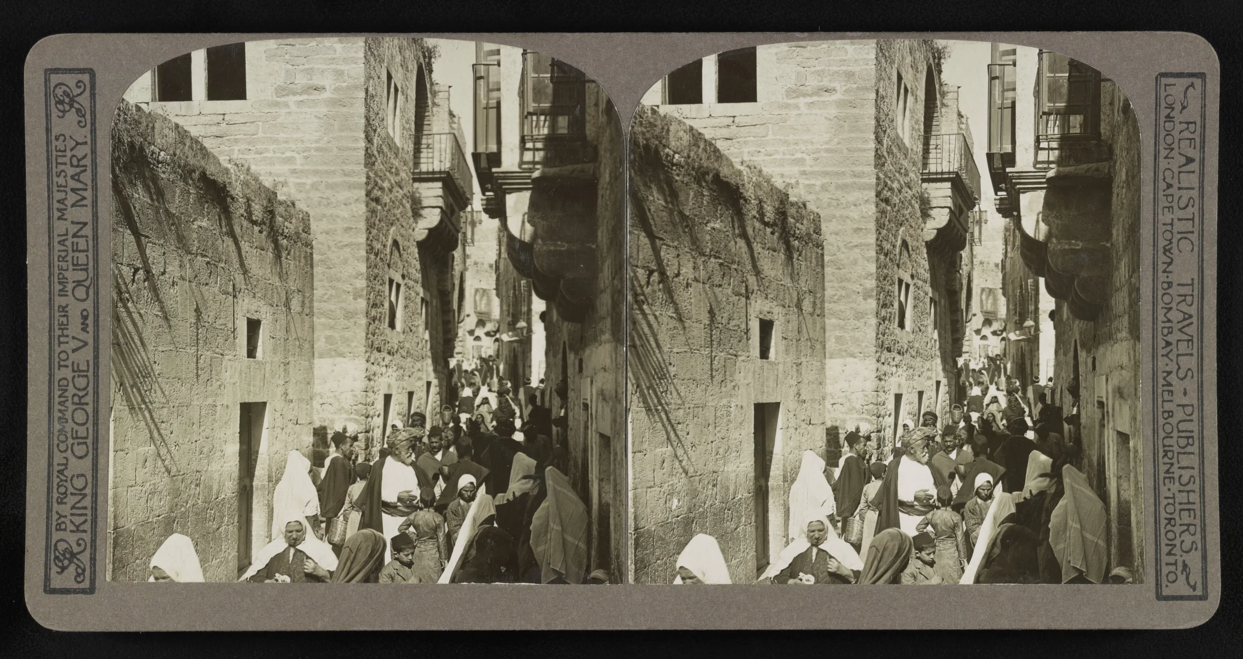 Black and white stereoscopic photograph of a busy street scene in Beirut, Lebanon, with numerous people in traditional clothing, stone buildings, and balconies, likely taken in the early 20th century.