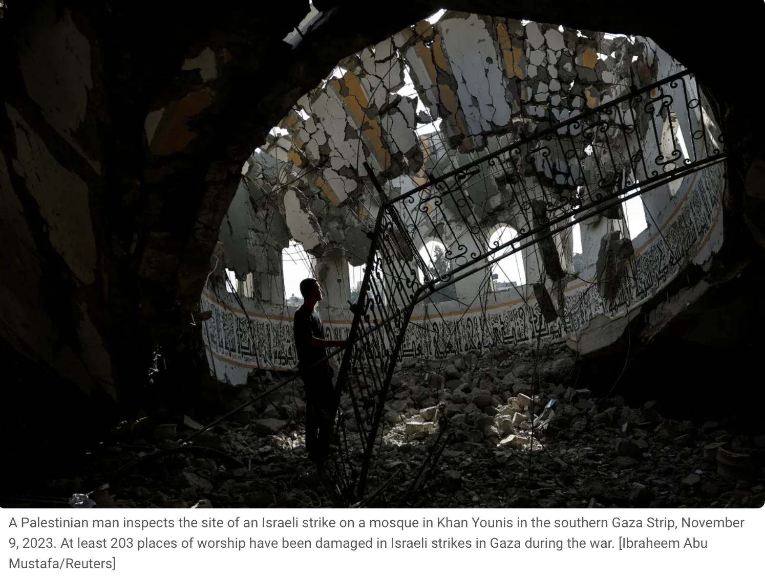 A Palestinian man inspects the site of an Israeli strike on a mosque in Khan Younis in the southern Gaza Strip, November 9, 2023. The mosque's interior is heavily damaged with debris on the ground, damaged ceiling, and broken ceiling panels, with sun