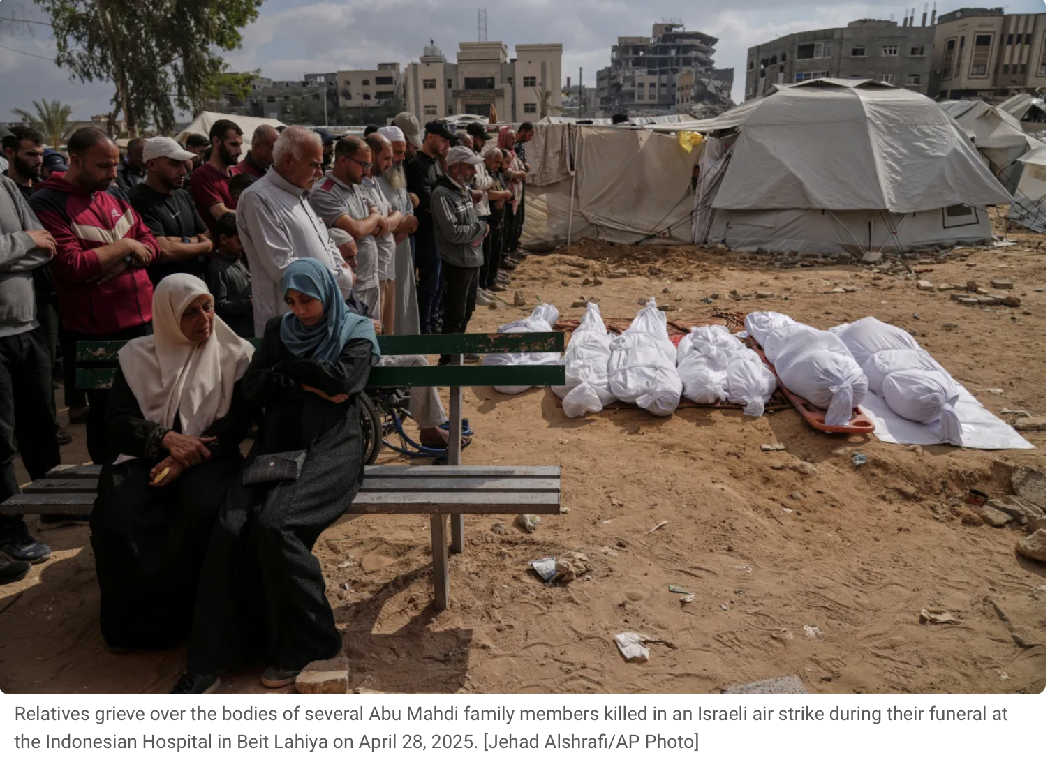 Relatives grieve over the bodies of several Abu Mahdi family members killed in an Israeli air strike during their funeral at the Indonesian Hospital in Beit Lahiya on April 28, 2025.
