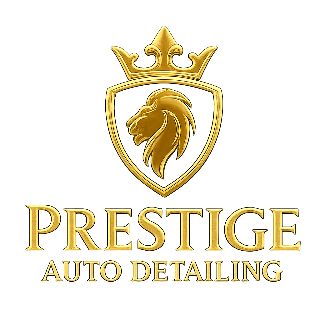Gold emblem featuring a lion's head inside a shield topped with a crown, with the words 'PRESTIGE AUTO DETAILING' beneath it.